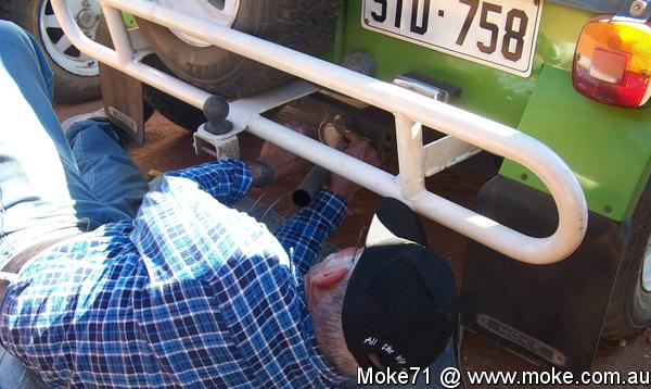 Vern tying up the exhaust on his Moke