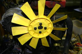 A picture of a yellow Plastic radiator fan from a Moke.