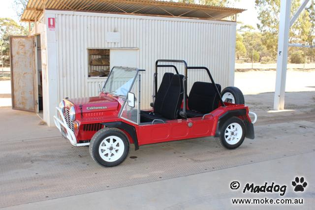 A pictuer of a red Moke parked on the weighbridge of a remote town in WA