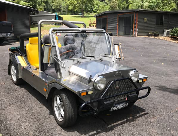 A stainless steel Super Moke with yellow seats