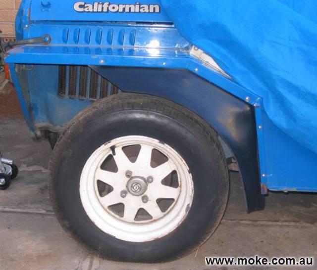 Photo of the front left side of a blue Moke