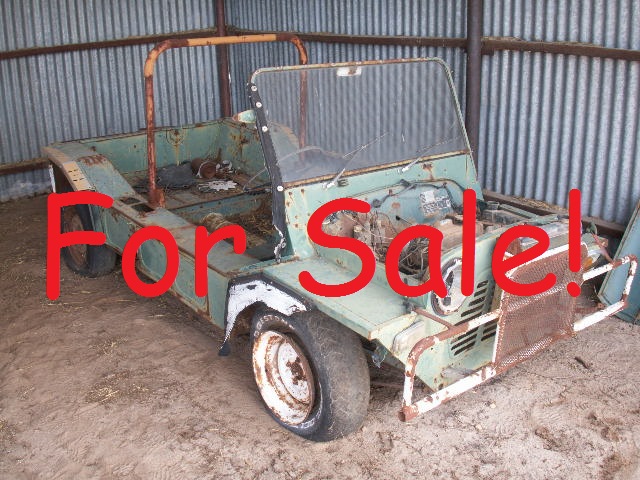 A picture of an old dust Moke in a shed with a for sale across it